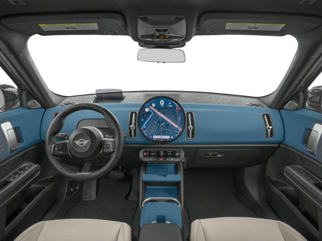Interior of a 2026 MINI Countryman S ALL4 featuring a round dashboard display, blue accents, and beige seats.