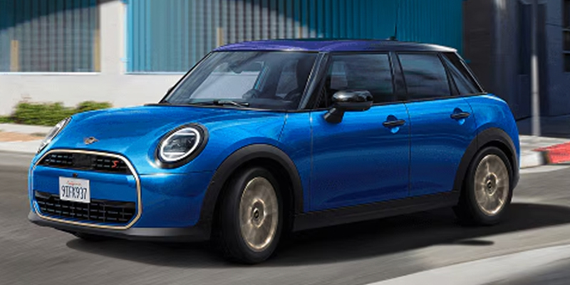 A bright blue 2026 MINI Hardtop 4-Door Cooper S driving on a street, showcasing its sporty design.