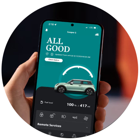 A hand holding up his phone with the MINI App open on the screen.