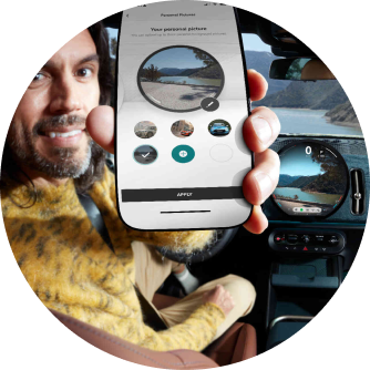 A man holding up his phone with the MINI App open on the screen.