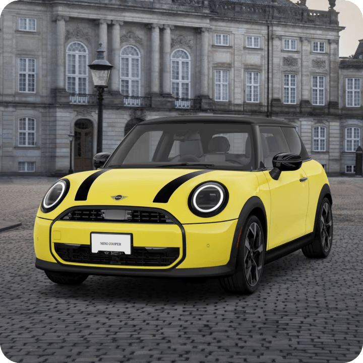 Angled view of MINI Cooper Oxford Editon parked in a cobblestone area.