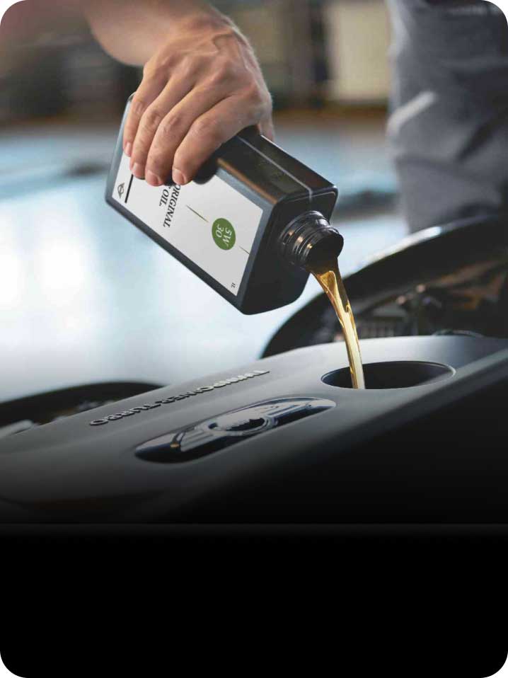 Oil being poured during an engine oil service.