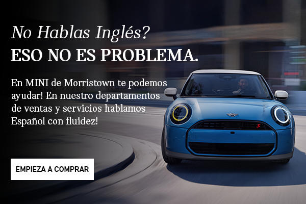 Front view of grey MINI Countryman with blue background.